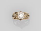 a gold ring with a white diamond in the center