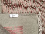 rug with red and white stripes and fringes on top of it