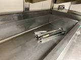 a metal sink in the middle of a kitchen