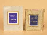 an image of a box of perfume sitting next to a box of perfume