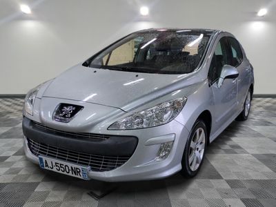 the small silver car is parked in a large room