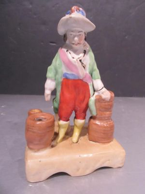 a figurine of a man sitting on a rock