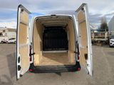 a white van with its doors open in a parking lot