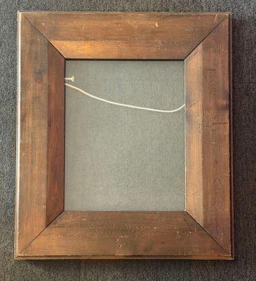 an old picture frame with a rope hanging from it ' s side