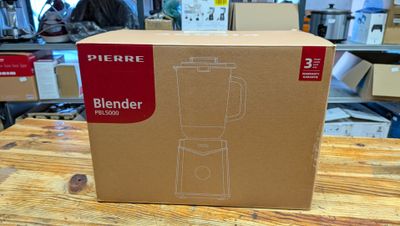 a box that has a blender in it on a table