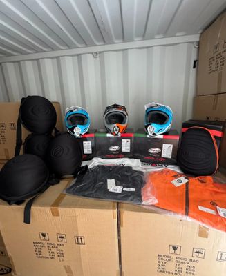 many boxes and helmets on top of each other in a container