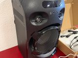 a speaker that is sitting on a table next to a box