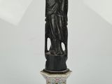 statue of a woman holding a bear on a pedestal