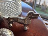 a dog figurine sitting on a table next to a vase