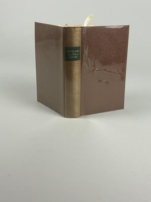 an old book sitting on top of a table next to a white background