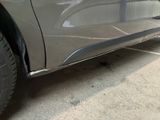 a close up of the side of a car that is painted silver