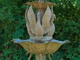 a statue of a bird on top of a fountain