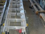 a picture of a long metal ladder in a warehouse