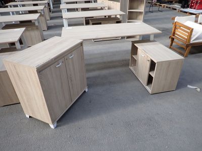 a lot of desks and chairs in a warehouse