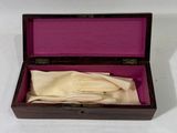 a small wooden box with a cloth inside of it