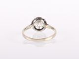 a close up of a diamond ring on a white surface