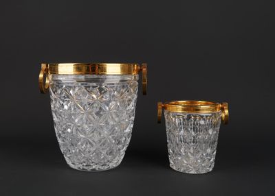 a pair of cut glass ice buckets with gold rims
