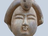 a statue of a woman with a bird on her head
