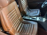 a brown leather seat in the back of a car