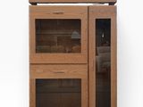 a wooden cabinet with two glass doors on it