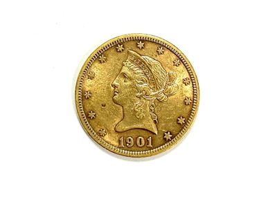 a close up of a gold coin on a white surface