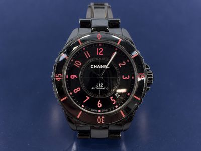 a close up of a watch on a blue surface