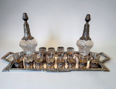 an image of a silver tray with glasses and a bottle on top of it