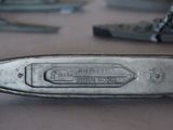 a knife that is laying on a table with other tools
