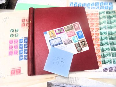 un livre rouge orné de timbres, posé sur une table
