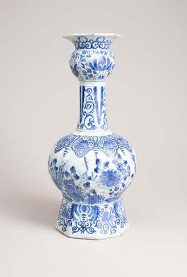 blue and white vase with a floral design on the bottom