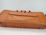 an image of a brown suitcase sitting on top of a white table