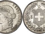 a silver coin with a cross on the front and a crown on the back