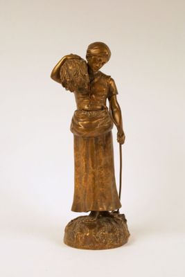 bronze statue of a woman with a basket of flowers on her head