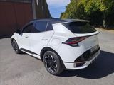the rear end of a white car parked in a parking lot
