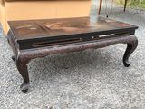 a coffee table with a drawer on top of it
