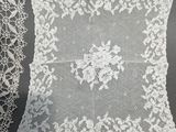 a close up of two white laces on a table