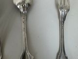 three spoons and a fork on a table