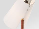 a close up of a lamp on a wooden pole with a white shade