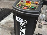 a black trash can with a yellow and red button on it