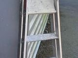 a ladder leaning up against a building next to a wall