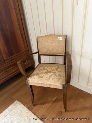 a chair in the corner of a room next to a cabinet