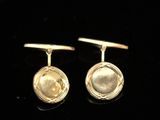 a pair of yellow gold cufflinks with a round design