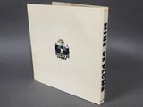 a white book with a black and white logo on it