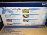 a cardboard box that has a picture of a quilting kit on it