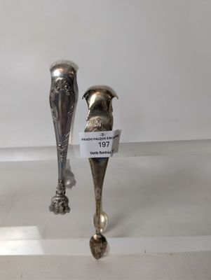 two silver spoons that are on display in a glass case
