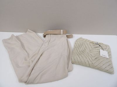 a pair of pants and a sweater sitting on a table