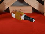 a bottle of wine that is sitting on a bed