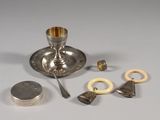 a silver plate with a spoon, spoon, and other items on it