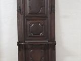 a tall wooden cabinet in the corner of a room