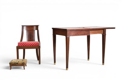 two chairs and a table with a red cushion on it